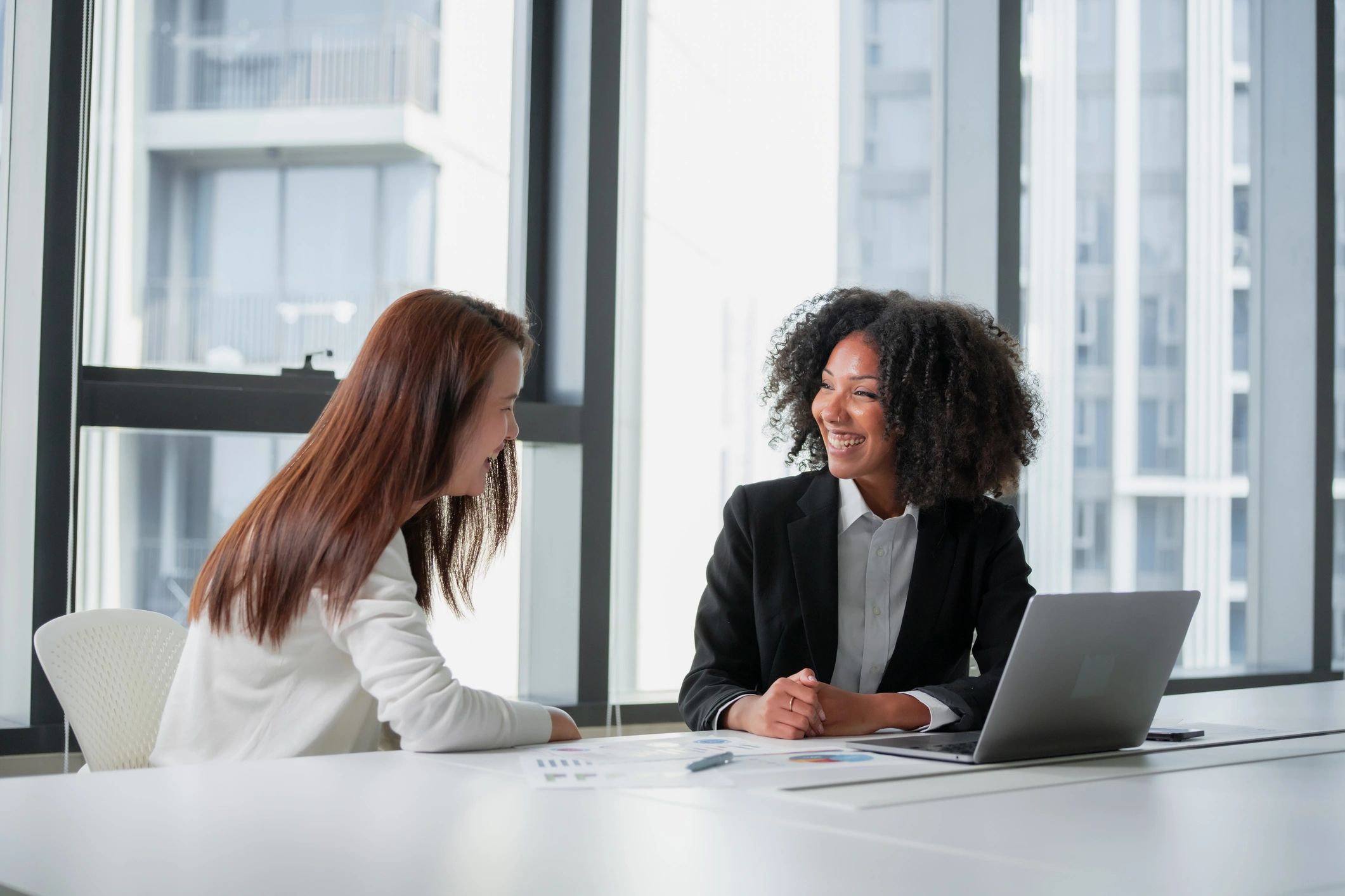 Jennifer Joy style business consultation meeting in a modern office